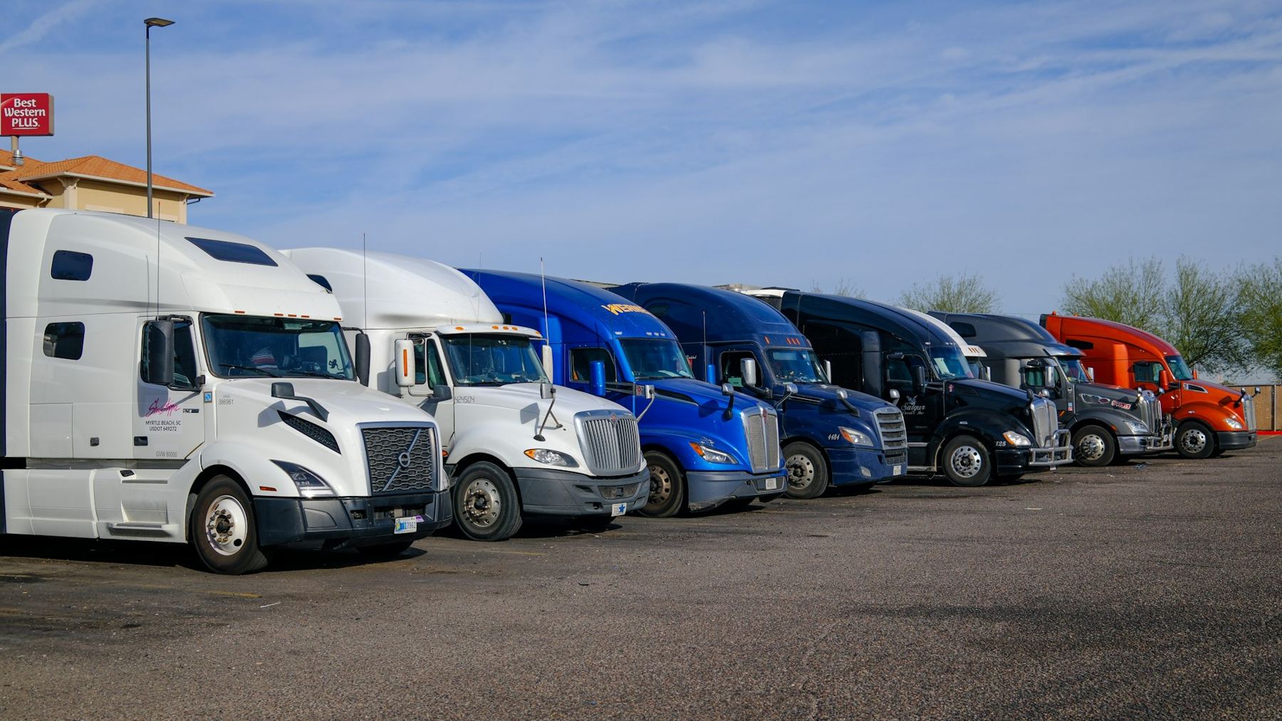 A row of trucks parked side by side